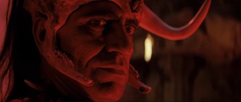 Movie still from “Indiana Jones and the Temple of Doom” (1984), directed by Steven Spielberg – A man's face in a red light; Close Up shot, Low angle