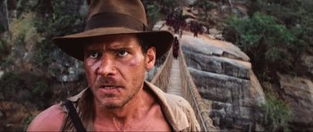 Movie still from “Indiana Jones and the Temple of Doom” (1984), directed by Steven Spielberg – A person wearing a hat; Close Up shot, Low angle