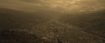 Movie still from “Infiesto” (2023), directed by Patxi Amezcua – An aerial view of a large city in the middle of the day; Extreme Wide shot, High angle