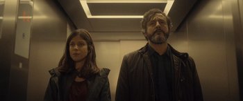 Movie still from “Infiesto” (2023), directed by Patxi Amezcua – A man and a woman standing next to each other; Medium shot, Low angle