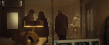 Movie still from “Infiesto” (2023), directed by Patxi Amezcua – A group of people standing next to each other in front of a window; Wide shot, Low angle