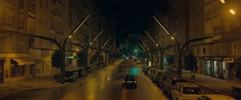 Movie still from “Infiesto” (2023), directed by Patxi Amezcua – A car driving down a street at night; Extreme Wide shot, Low angle
