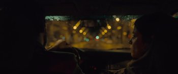 Movie still from “Infiesto” (2023), directed by Patxi Amezcua – A view from inside a car at night with lights; Close Up shot, Over the shoulder angle