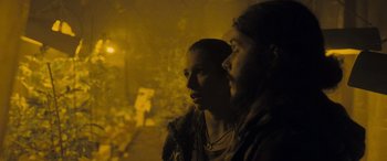 Movie still from “Infiesto” (2023), directed by Patxi Amezcua – A man and a woman standing next to each other in the dark; Medium shot, Low angle