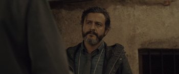 Movie still from “Infiesto” (2023), directed by Patxi Amezcua – A person with a beard; Close Up shot, Low angle