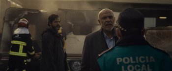 Movie still from “Infiesto” (2023), directed by Patxi Amezcua – A man in a black jacket is talking to a woman; Medium shot, Low angle