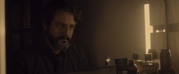 Movie still from “Infiesto” (2023), directed by Patxi Amezcua – A man sitting in front of a computer monitor; Close Up shot, Over the shoulder angle