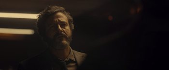 Movie still from “Infiesto” (2023), directed by Patxi Amezcua – A man with a gray beard is looking at the camera; Close Up shot, Low angle