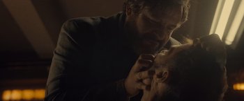 Movie still from “Infiesto” (2023), directed by Patxi Amezcua – A man is shaving his face while a woman looks at him; Close Up shot, Over the shoulder angle