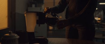 Movie still from “Infiesto” (2023), directed by Patxi Amezcua – A person is pouring something from a coffee pot into a cup; Extreme Close Up shot, High angle