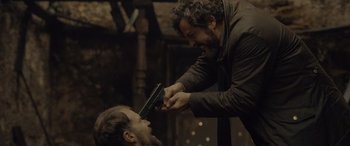 Movie still from “Infiesto” (2023), directed by Patxi Amezcua – A man getting his head shaved by another man; Medium shot, Over the shoulder angle