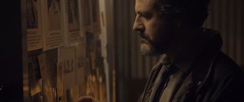 Movie still from “Infiesto” (2023), directed by Patxi Amezcua – A person with a beard; Close Up shot, Over the shoulder angle