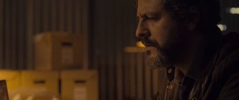 Movie still from “Infiesto” (2023), directed by Patxi Amezcua – A person smoking a cigarette; Close Up shot, Over the shoulder angle