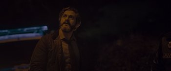 Movie still from “Infiesto” (2023), directed by Patxi Amezcua – A man with a beard is looking into the distance; Close Up shot, Low angle