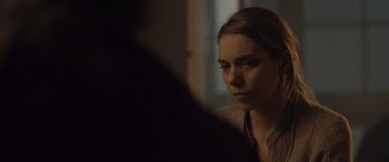 Movie still from “Infiesto” (2023), directed by Patxi Amezcua – A woman looking at her reflection in a mirror; Close Up shot, Over the shoulder angle