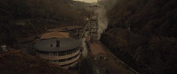 Movie still from “Infiesto” (2023), directed by Patxi Amezcua – An aerial view of an old gold mine; Extreme Wide shot, High angle