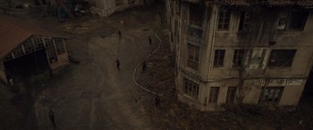 Movie still from “Infiesto” (2023), directed by Patxi Amezcua – A group of people standing next to each other on a dirt road; Extreme Wide shot, High angle