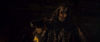Movie still from “Infiesto” (2023), directed by Patxi Amezcua – An old man dressed in a fur coat and mask; Medium shot, Over the shoulder angle