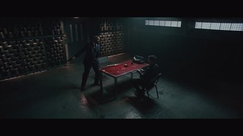 Movie still from “Infinite” (2021), directed by Antoine Fuqua – Two men playing a game of pool in a dark room; Wide shot, High angle