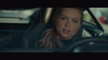 Movie still from “Infinite” (2021), directed by Antoine Fuqua – A woman sitting in the driver's seat of a car; Close Up shot, Over the shoulder angle