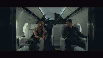 Movie still from “Infinite” (2021), directed by Antoine Fuqua – A man and a woman sitting on a plane; Wide shot, High angle