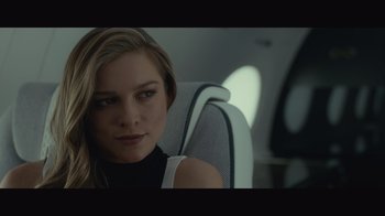 Movie still from “Infinite” (2021), directed by Antoine Fuqua – A beautiful young lady sitting in a chair; Close Up shot, Over the shoulder angle