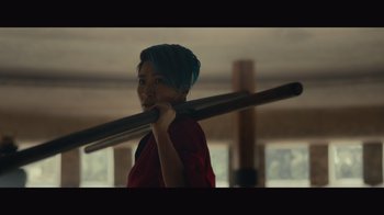 Movie still from “Infinite” (2021), directed by Antoine Fuqua – A person holding a large wooden stick in their hands; Close Up shot, Low angle