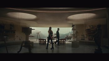 Movie still from “Infinite” (2021), directed by Antoine Fuqua – A man and a woman are walking in a room; Wide shot, Low angle