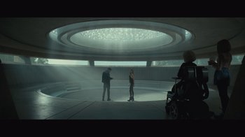 Movie still from “Infinite” (2021), directed by Antoine Fuqua – Two people standing in a room with a light shining on them; Wide shot, High angle