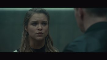 Movie still from “Infinite” (2021), directed by Antoine Fuqua – A woman is looking at a man in the mirror; Close Up shot, Over the shoulder angle