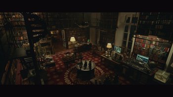 Movie still from “Infinite” (2021), directed by Antoine Fuqua – A room filled with lots of furniture and lamps; Extreme Wide shot, High angle