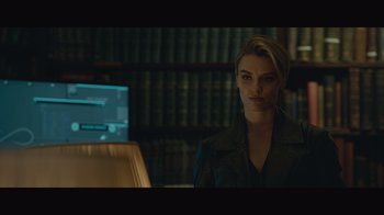 Movie still from “Infinite” (2021), directed by Antoine Fuqua – A woman is standing in front of a computer screen; Medium shot, Over the shoulder angle