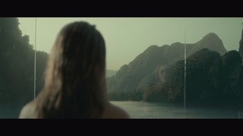 Movie still from “Infinite” (2021), directed by Antoine Fuqua – A woman looking out over a body of water; Extreme Wide shot, Over the shoulder angle