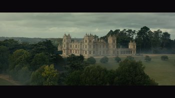 Movie still from “Infinite” (2021), directed by Antoine Fuqua – A large castle with a forest in the background; Extreme Wide shot, High angle