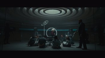 Movie still from “Infinite” (2021), directed by Antoine Fuqua – A group of people sitting in a circle in a room; Wide shot, Overhead angle