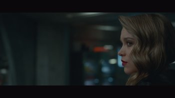 Movie still from “Infinite” (2021), directed by Antoine Fuqua – A beautiful young lady looking over her shoulder at the camera; Close Up shot, Low angle