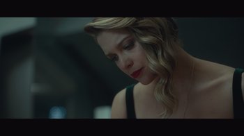 Movie still from “Infinite” (2021), directed by Antoine Fuqua – A beautiful woman with long blonde hair looking down at her face; Close Up shot, Low angle