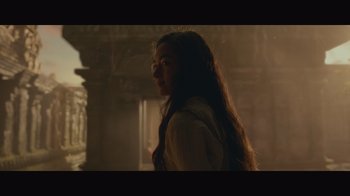 Movie still from “Infinite” (2021), directed by Antoine Fuqua – A woman with long hair standing in a dimly lit room; Close Up shot, Low angle