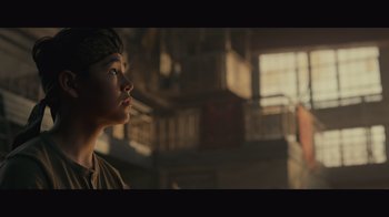 Movie still from “Infinite” (2021), directed by Antoine Fuqua – A young person is looking up at the sky; Close Up shot, Low angle