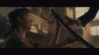 Movie still from “Infinite” (2021), directed by Antoine Fuqua – A man holding a baseball bat in his hands; Close Up shot, Over the shoulder angle