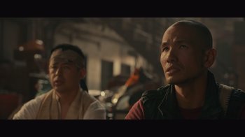 Movie still from “Infinite” (2021), directed by Antoine Fuqua – Two asian men sitting next to each other in a room; Close Up shot, Low angle