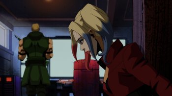 Movie still from “Injustice” (2021), directed by Matt Peters – A woman with long blonde hair is looking at the camera; Medium shot, Over the shoulder angle