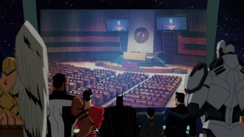 Movie still from “Injustice” (2021), directed by Matt Peters – A group of people standing in front of a large screen; Extreme Wide shot, High angle