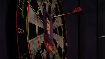 Movie still from “Injustice” (2021), directed by Matt Peters – A dart board with a picture of superman on it; Extreme Close Up shot, Over the shoulder angle