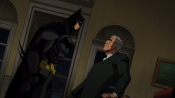 Movie still from “Injustice” (2021), directed by Matt Peters – A man and a batman talking to each other; Wide shot, Over the shoulder angle