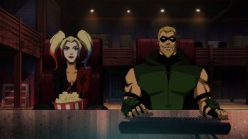Movie still from “Injustice” (2021), directed by Matt Peters – A man and a woman sitting at a table with popcorn; Wide shot, Low angle