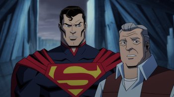 Movie still from “Injustice” (2021), directed by Matt Peters – A man standing next to another man in a cartoon; Medium shot, Over the shoulder angle