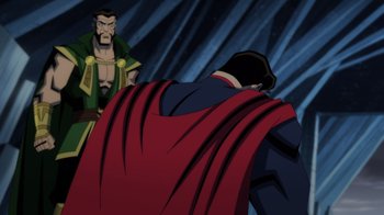 Movie still from “Injustice” (2021), directed by Matt Peters – A man in a red cape and a man in a green cape; Medium shot, Over the shoulder angle