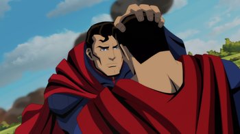 Movie still from “Injustice” (2021), directed by Matt Peters – A man in a red and blue cape holding a black object in his hand; Close Up shot, Over the shoulder angle
