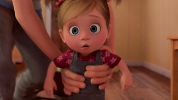 Movie still from “Inside Out” (2015), directed by Pete Docter – A cartoon of a girl holding a baby doll; Close Up shot, High angle